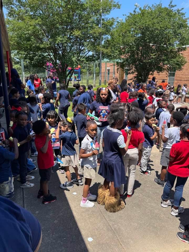 JPS Scholars enjoying frozen treats outdoors during field day